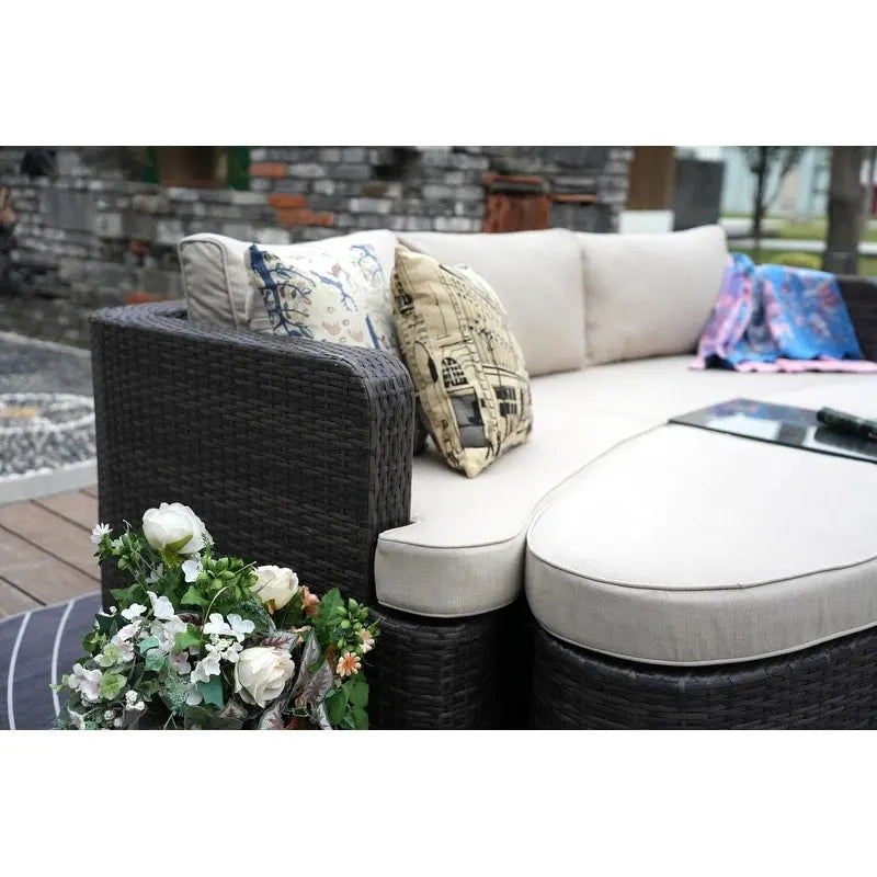Set da esterno 9 pezzi con divano letto in vimini e tavolo braciere in cemento