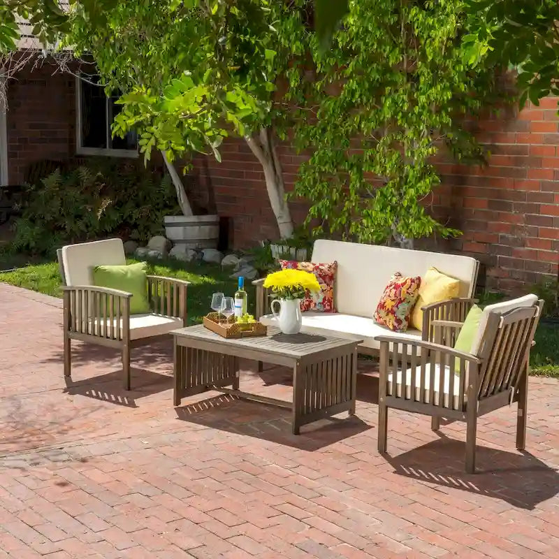 Set da 4 pezzi per patio in legno con tavolo in legno di acacia e cuscini